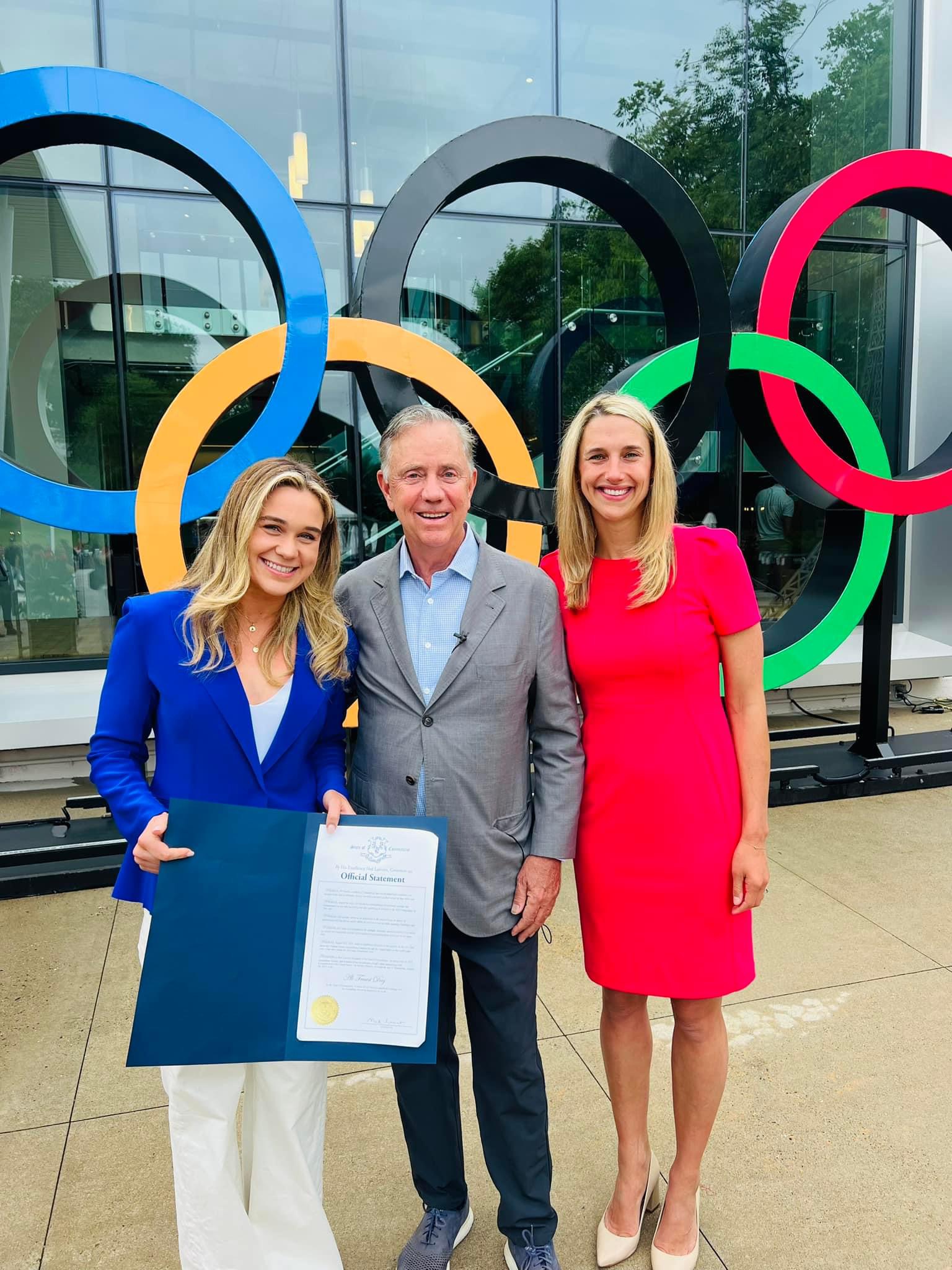 Mayor Simmons smiles with Governor Lamont and Ali infront of NBC Sports